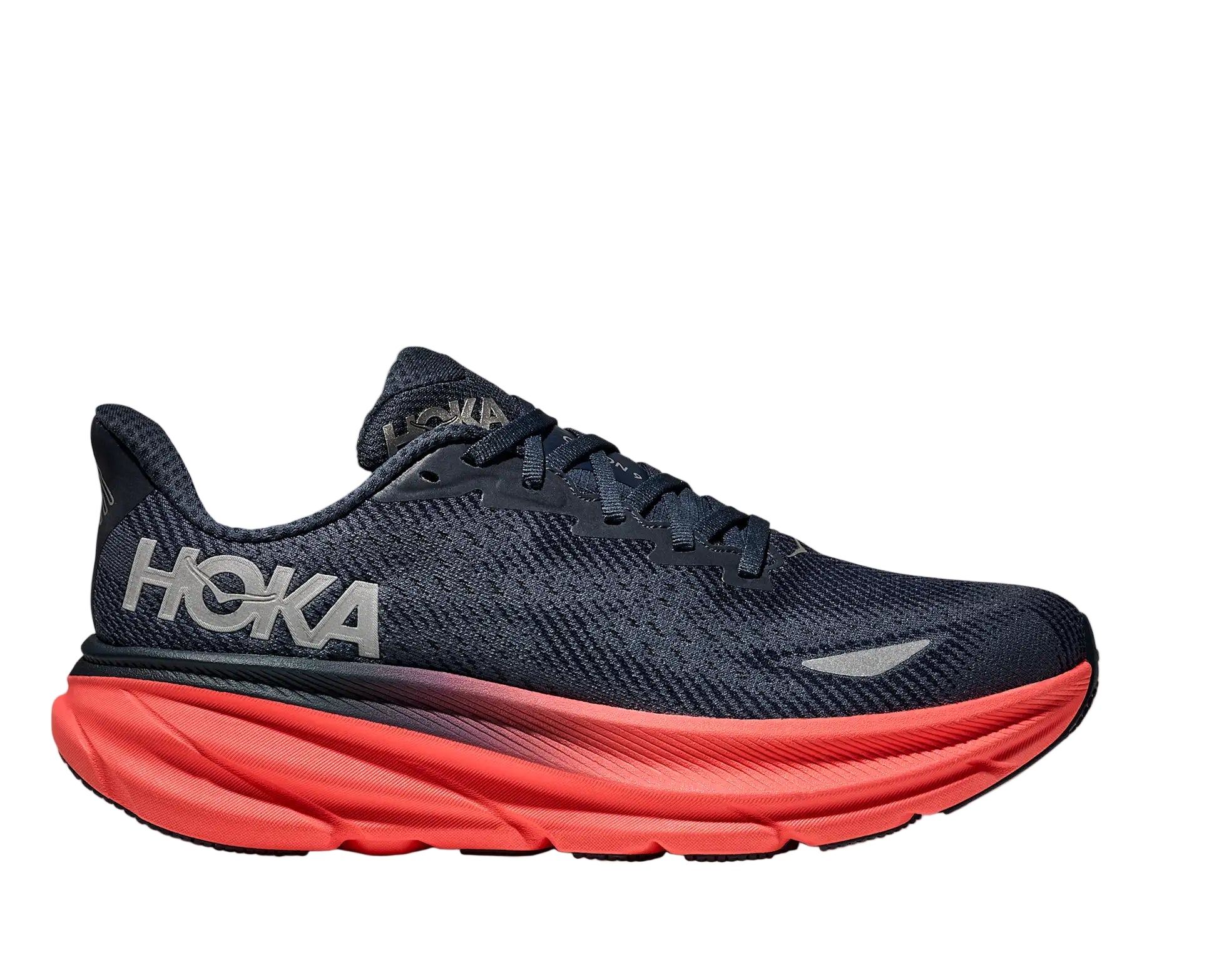 Navy running shoe with red sole on a white background