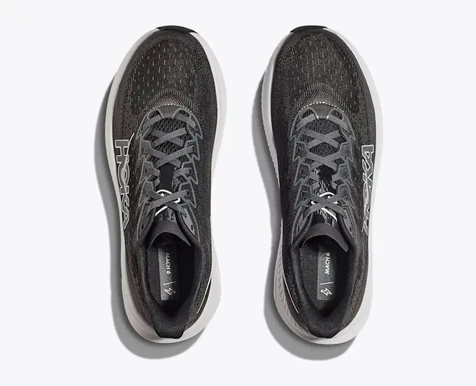 Black running shoe with white sole on a light gray background