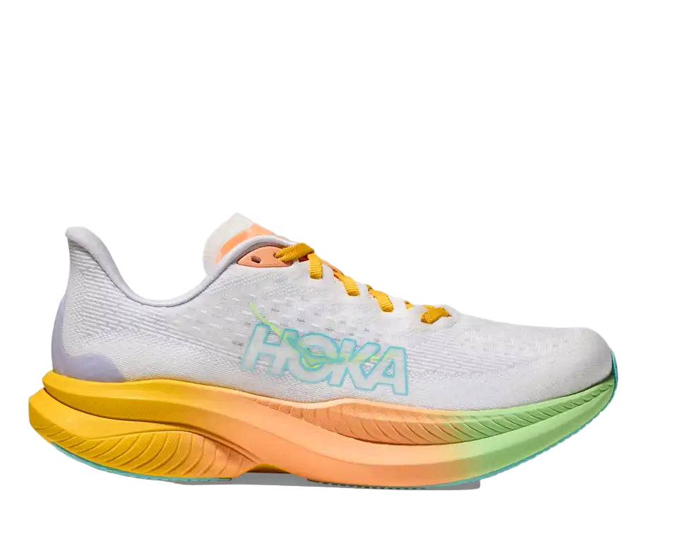 White running shoe with yellow and green sole on a white background