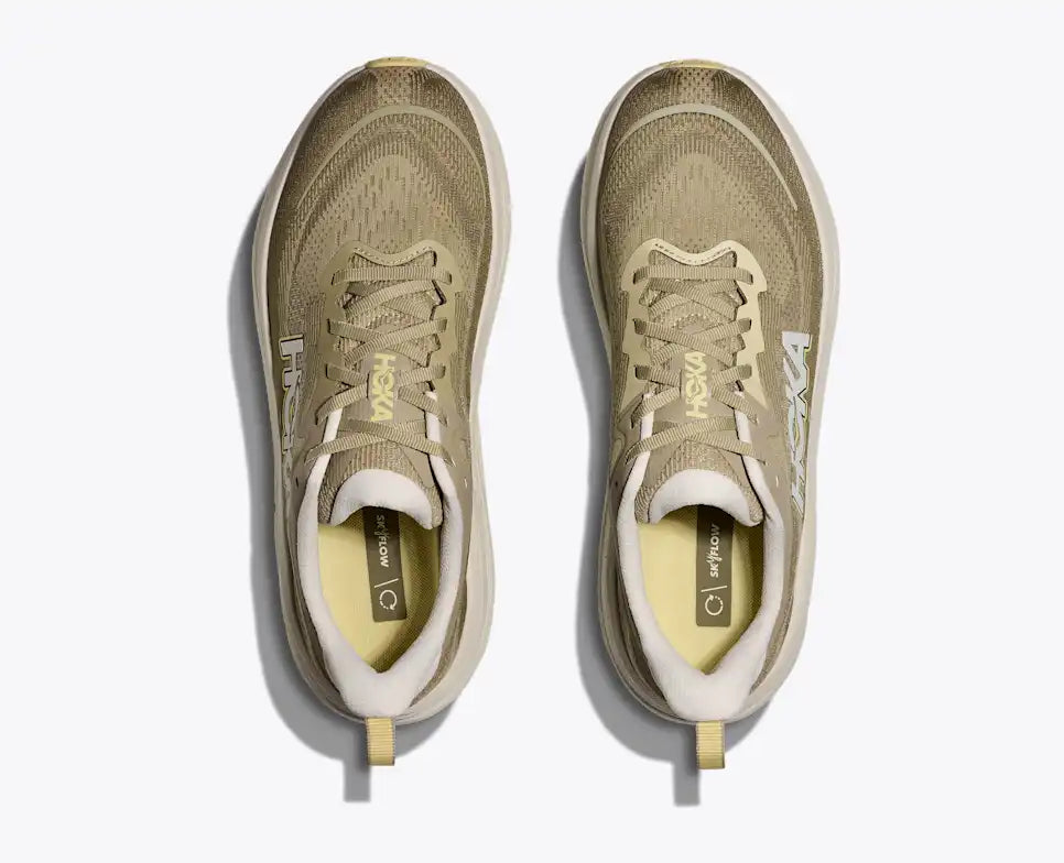Brown running shoe with 'Hoka' branding on a white background