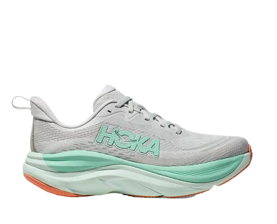 Gray running shoe with green sole and 'Hoka' branding on a white background