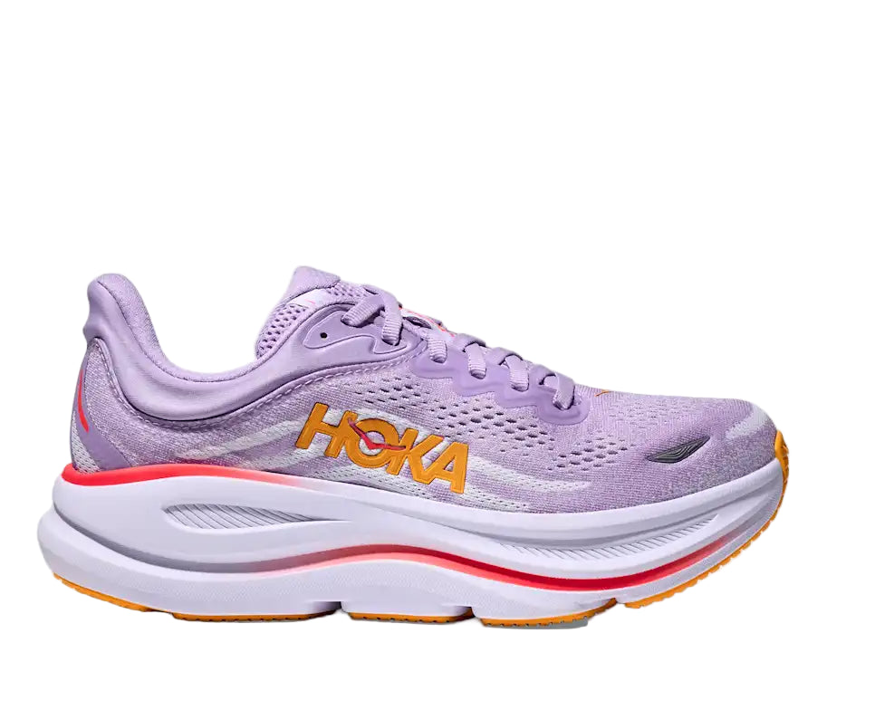 Purple running shoe with orange sole on a white background