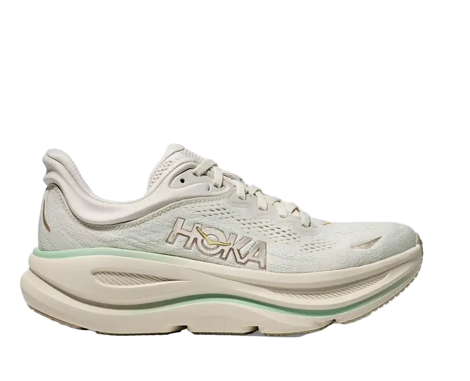 White running shoe with green accents on a light gray background