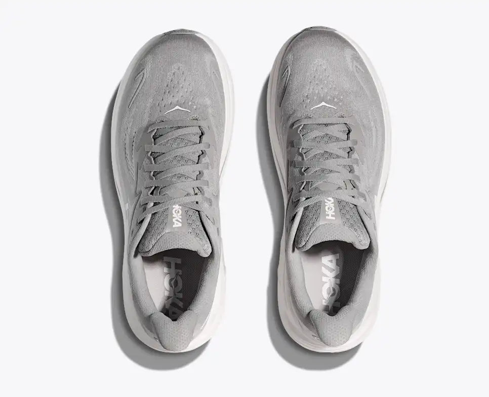 Gray running shoe with white sole on a white background