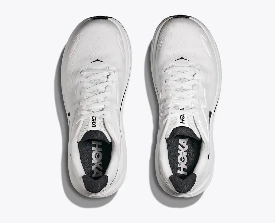 White running shoe with black 'Hoka' logo on a white background