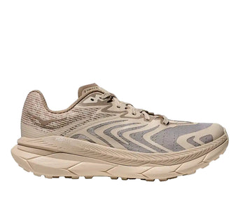 Beige running shoe with wavy pattern on a white background
